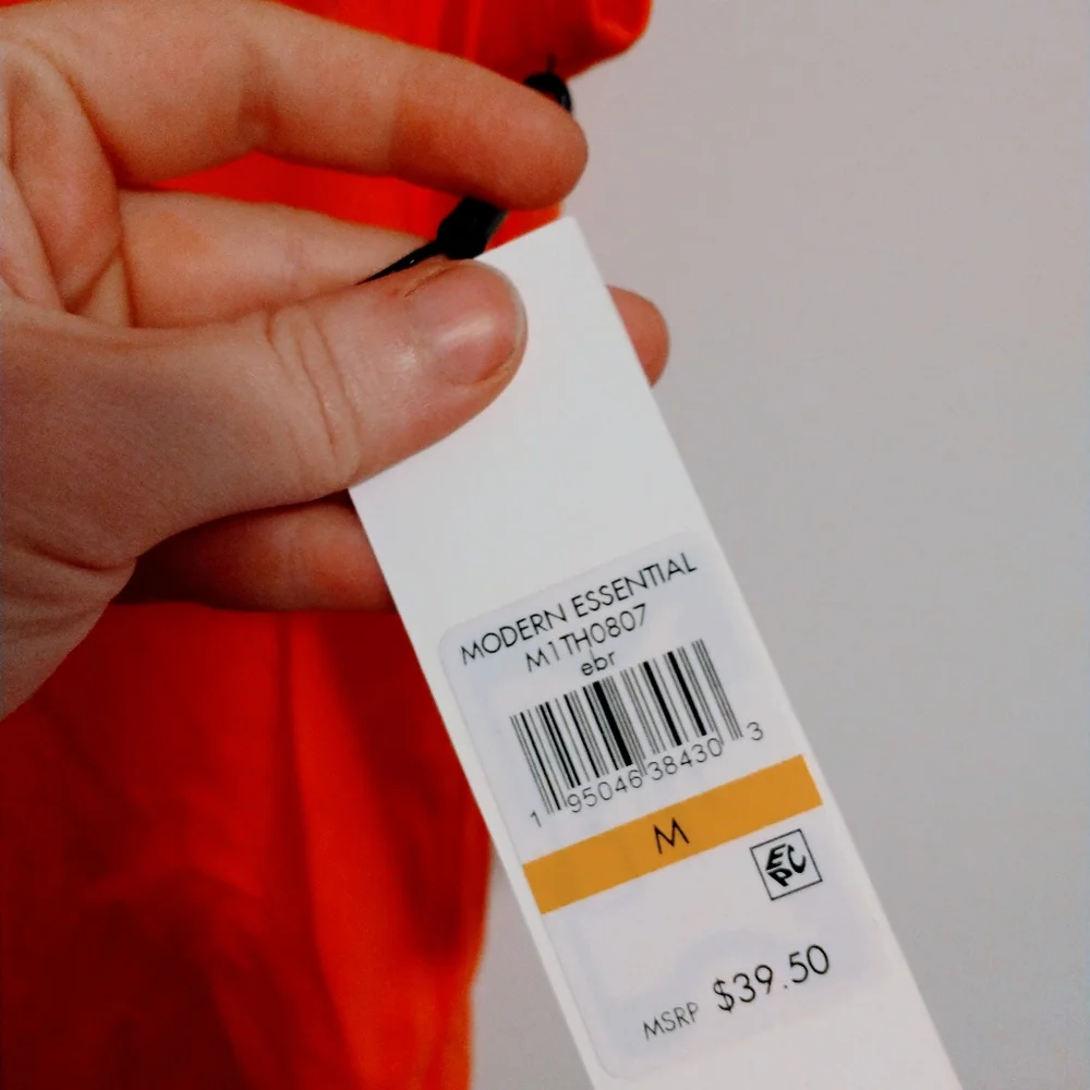 NWOT Calvin Klein orange short sleeve top with half button front detail.  Size